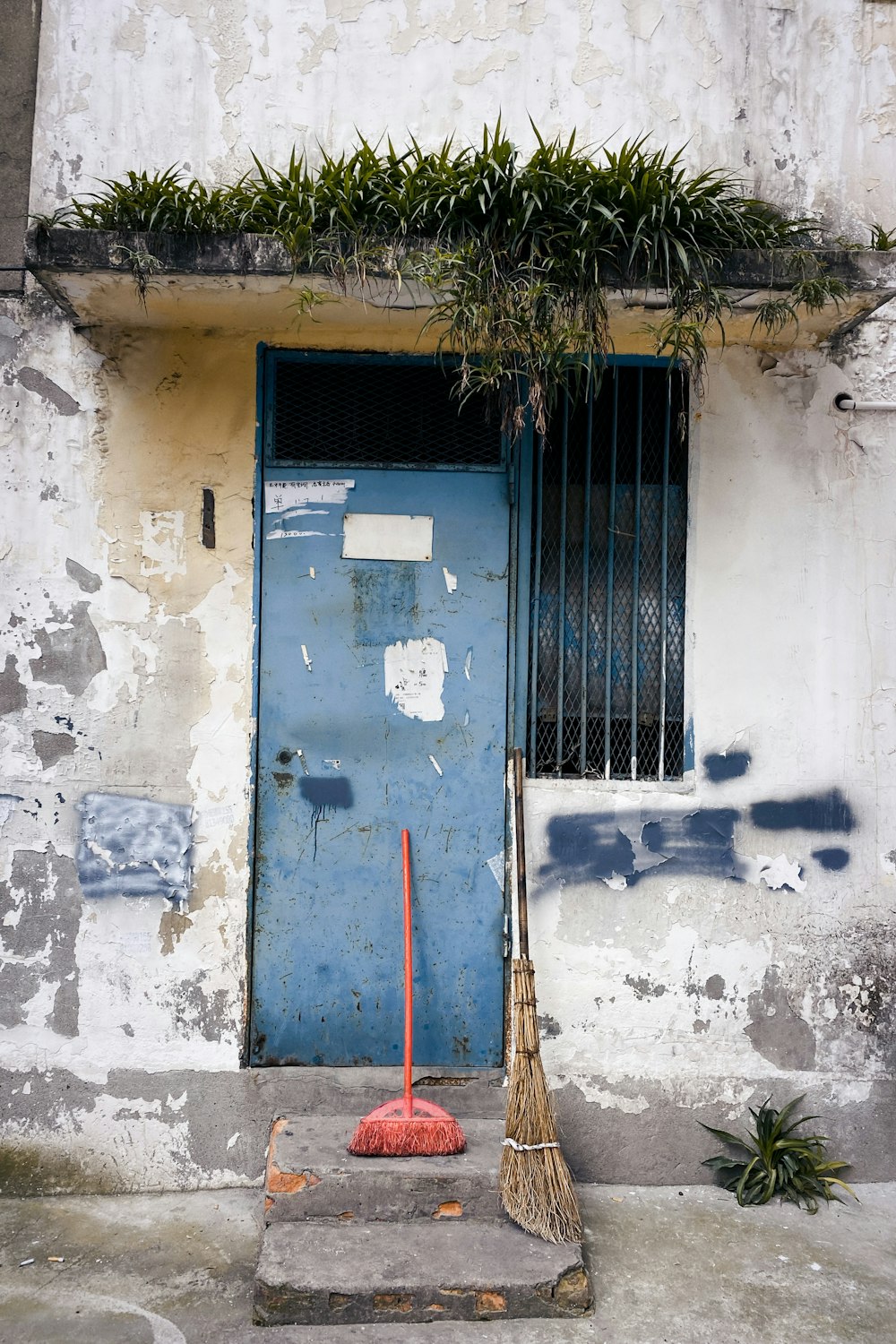 gray metal door on white concrete wall