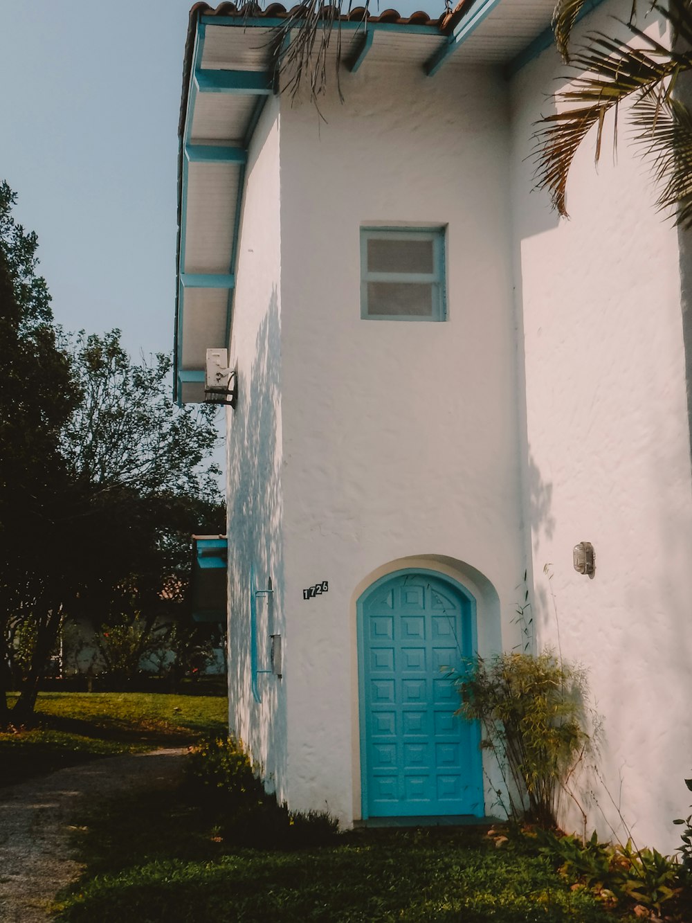 white concrete building with blue door