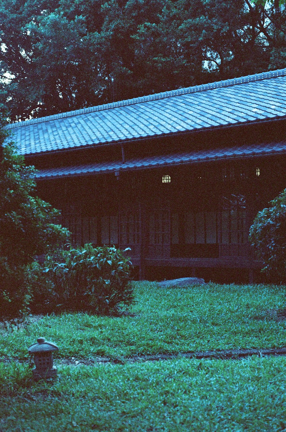 brown wooden house near green trees during daytime