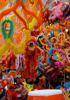 Colorful carnival masks and festive decorations at a lively street celebration in Remda.