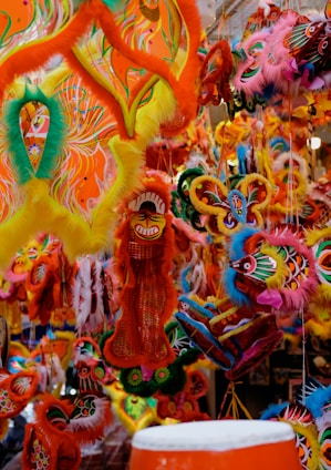 A group of artisans crafting colorful carnival masks in a lively workshop.