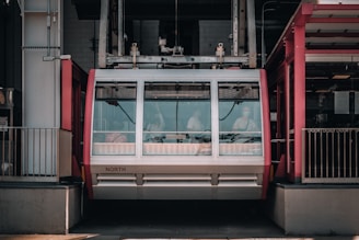 Technical blueprint sketches of cable car components spread out on a wooden desk.