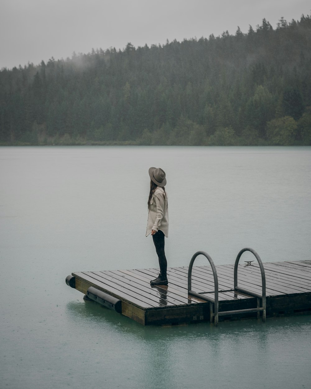 woman in brown coat standing on dock during daytime