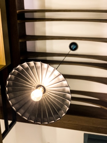 A farmhouse flush mount light fixture blending seamlessly with a wooden ceiling beam.