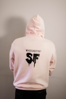 person in pink hoodie standing