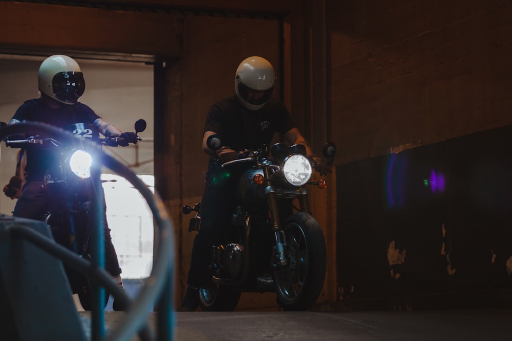 black and gray motorcycle parked beside blue metal fence