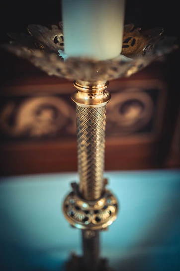 Close-up of a handcrafted metal candle holder with intricate detailing.