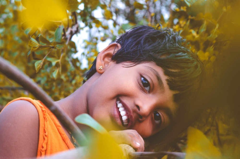 smiling woman in orange shirt