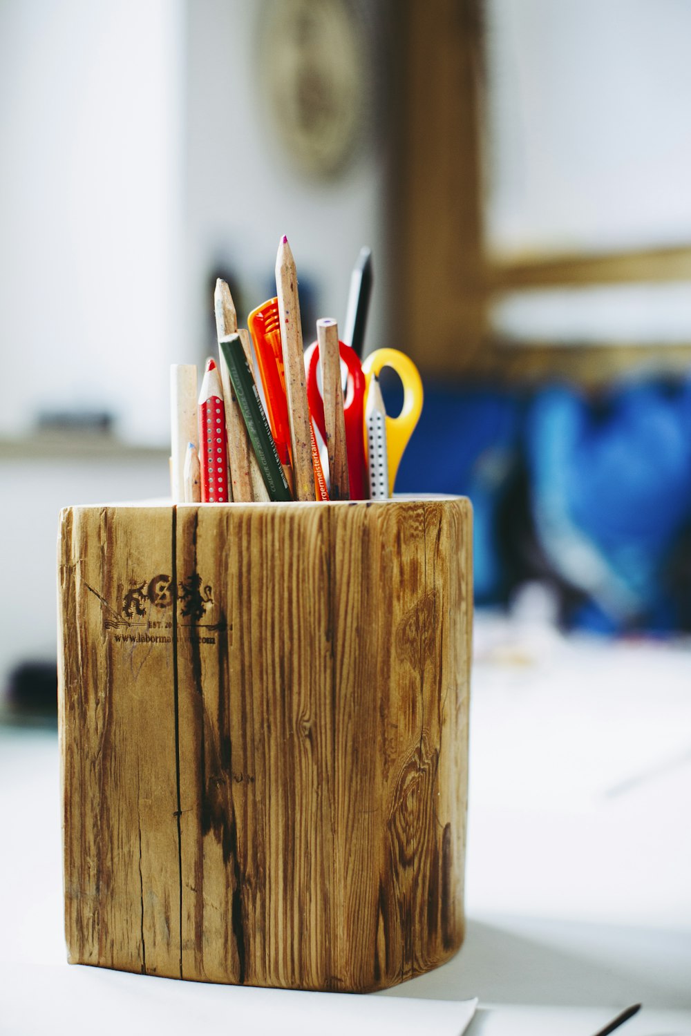 yellow and orange scissors on brown wooden box