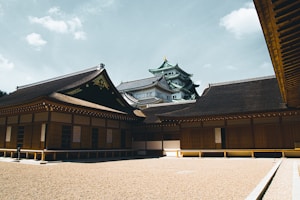 brown and black concrete building under white clouds during daytime