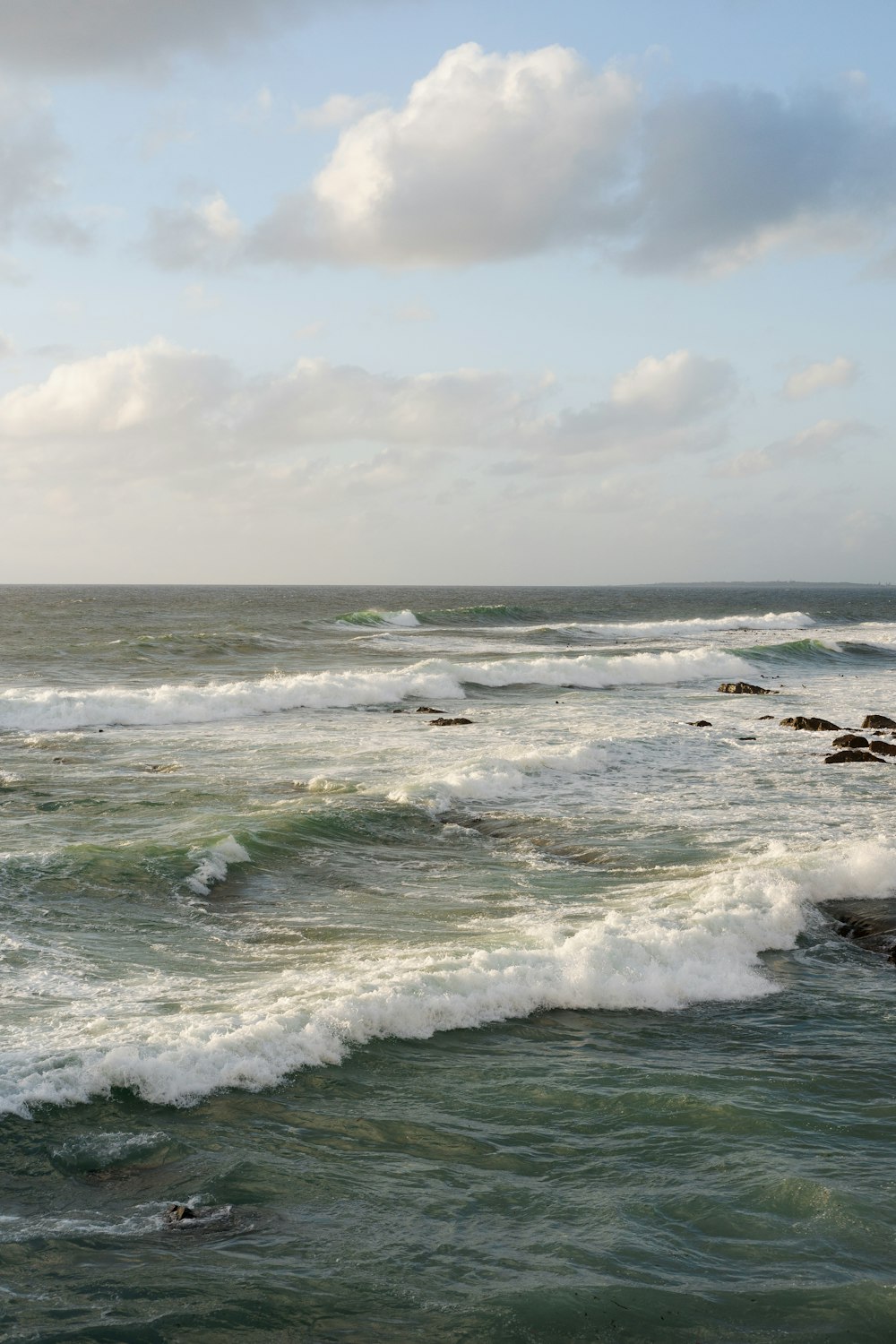 ocean waves crashing on shore during daytime