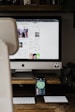 silver imac on brown wooden table