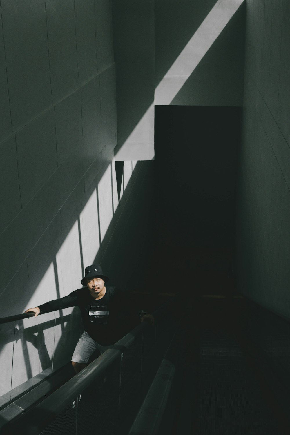 man in black jacket sitting on stairs