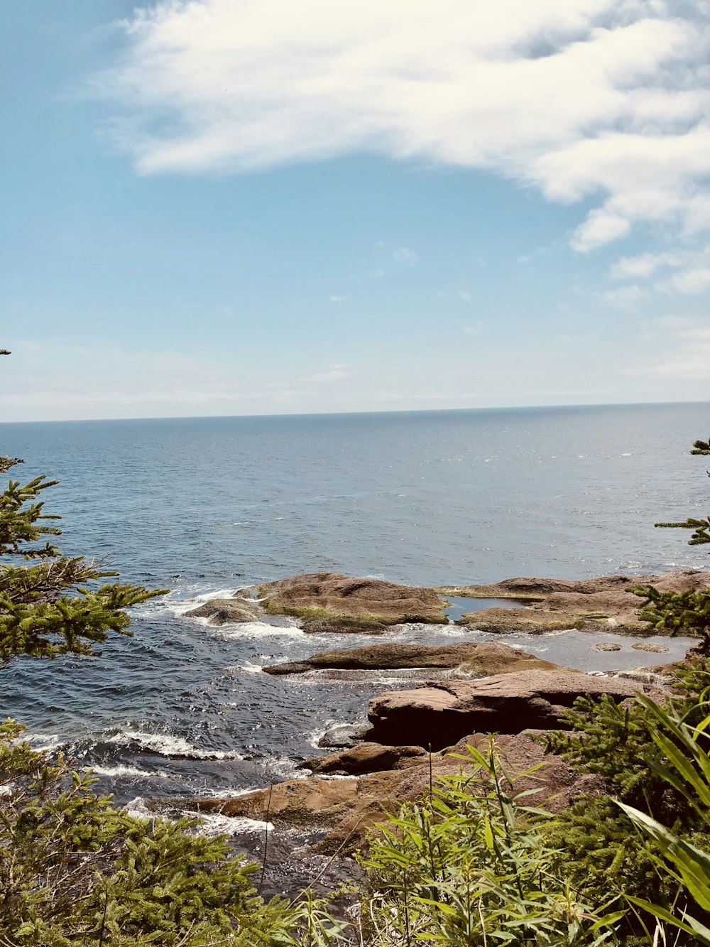 brown rock formation near body of water during daytime