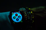 Smartwatch displaying health stats with a vibrant display against a minimalist background.