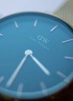 Detail shot of the watch face showing the clean, minimalist dial with subtle branding.