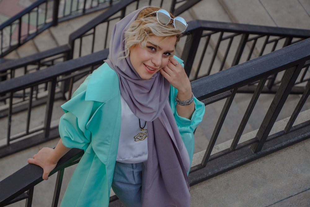 woman in blue robe wearing blue sunglasses