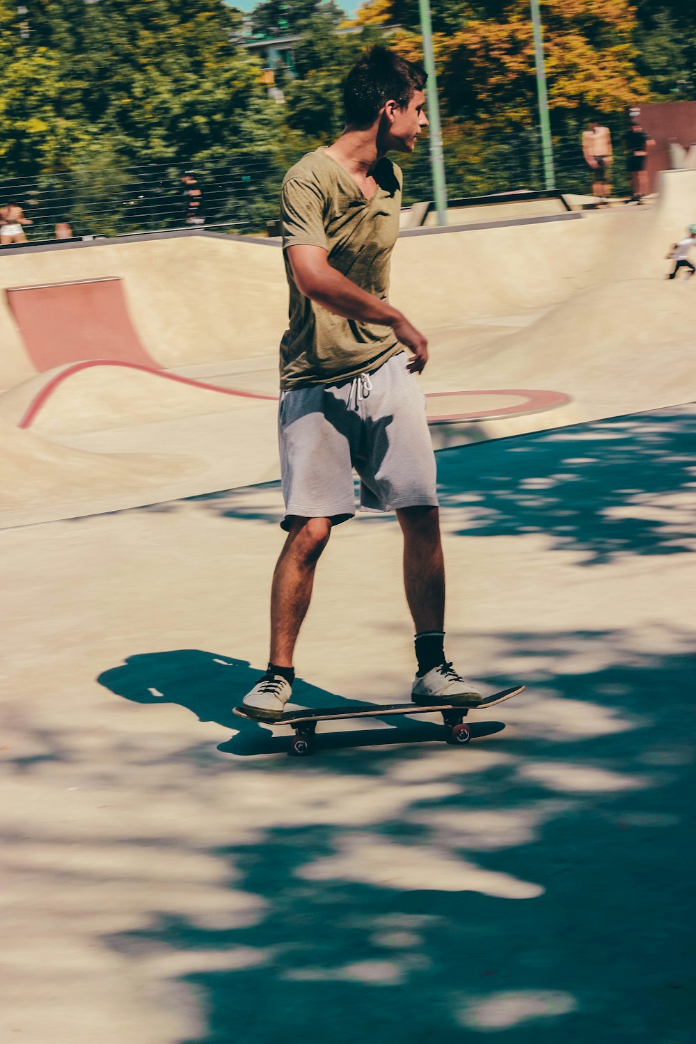 man in white shorts and black shoes playing skateboard during daytime