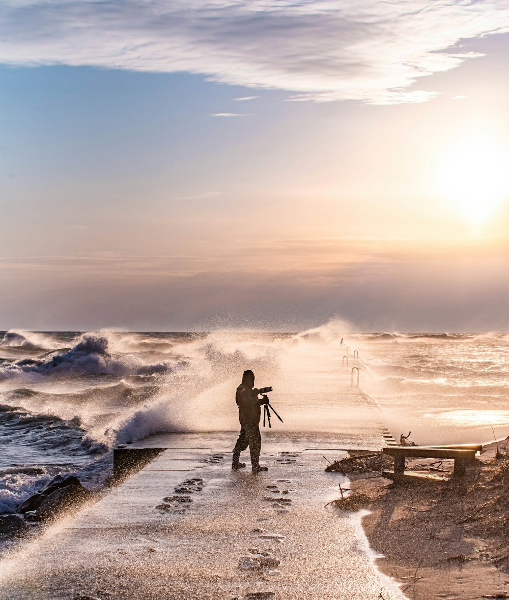 person standing on beach during sunset