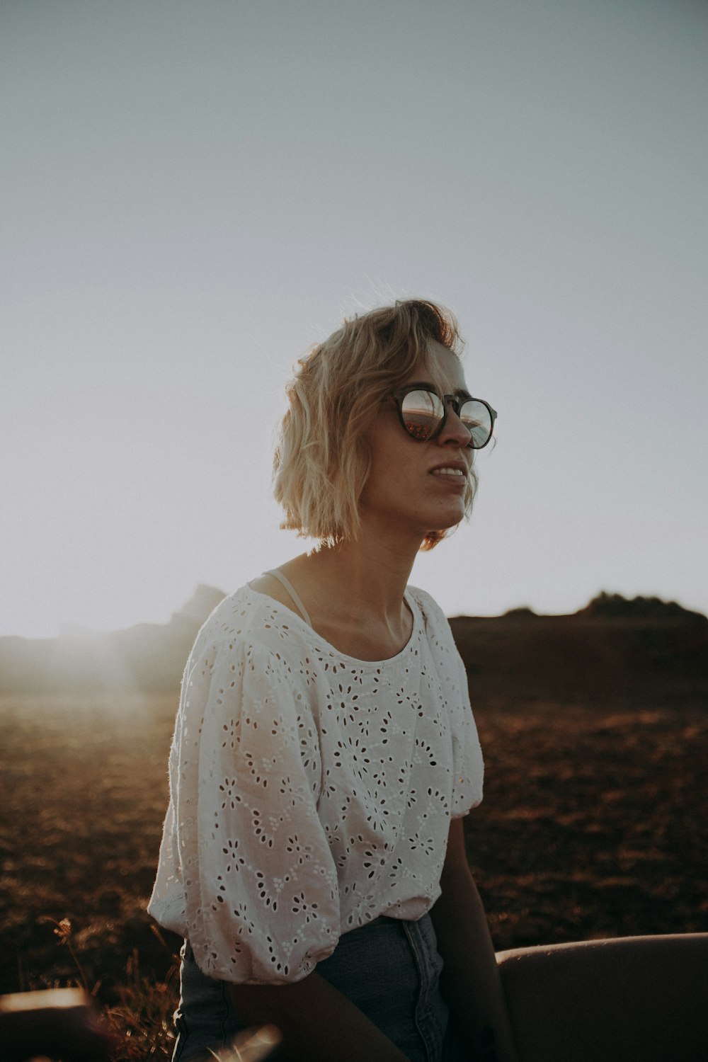 woman in white crew neck shirt wearing black sunglasses during daytime