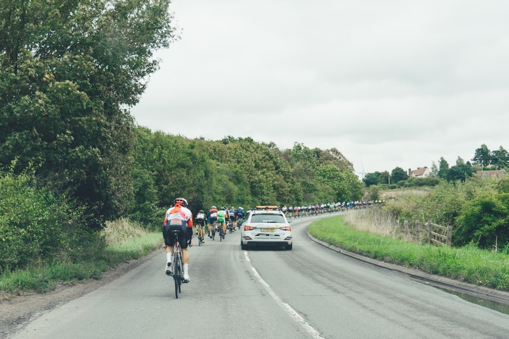 2 men riding bicycle on road during daytime