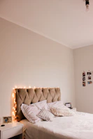 white and brown throw pillows on white bed