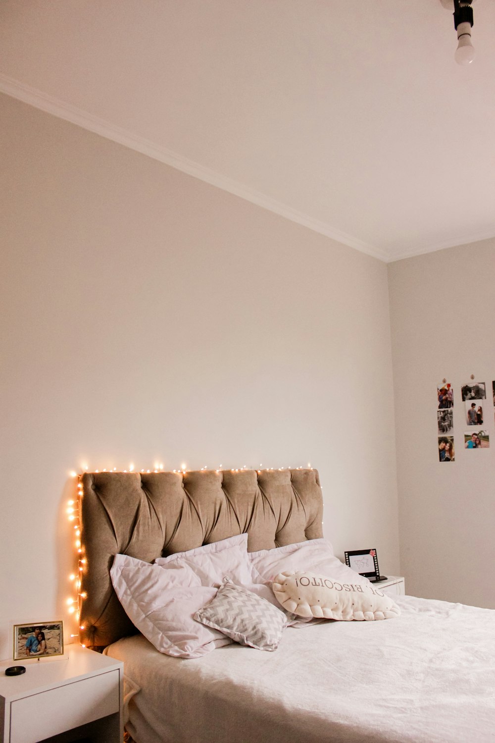 white and brown throw pillows on white bed