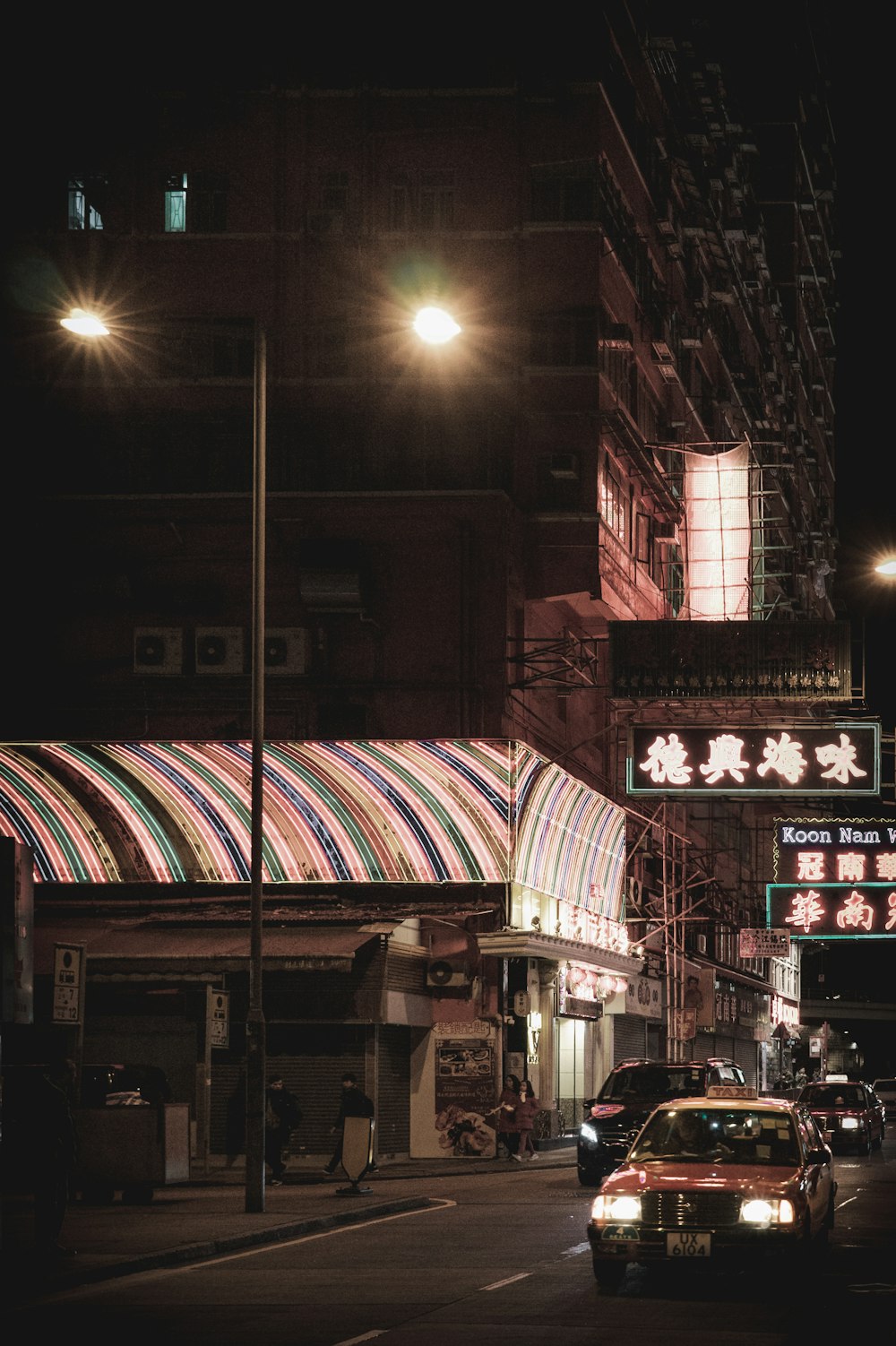 cars parked in front of store during night time