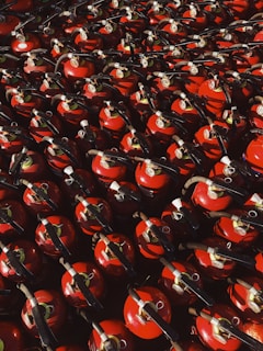 red and black ceramic mugs on black steel rack
