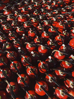 red and black ceramic mugs on black steel rack