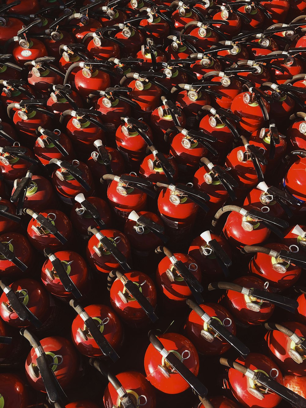 red and black ceramic mugs on black steel rack