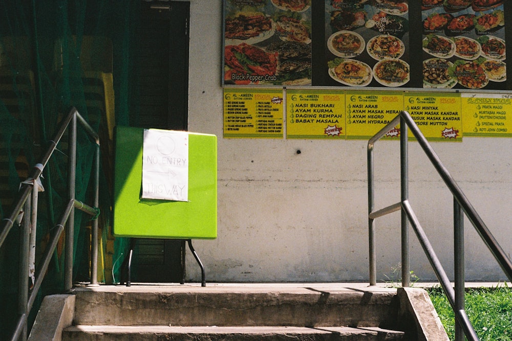 green and white poster on white wall