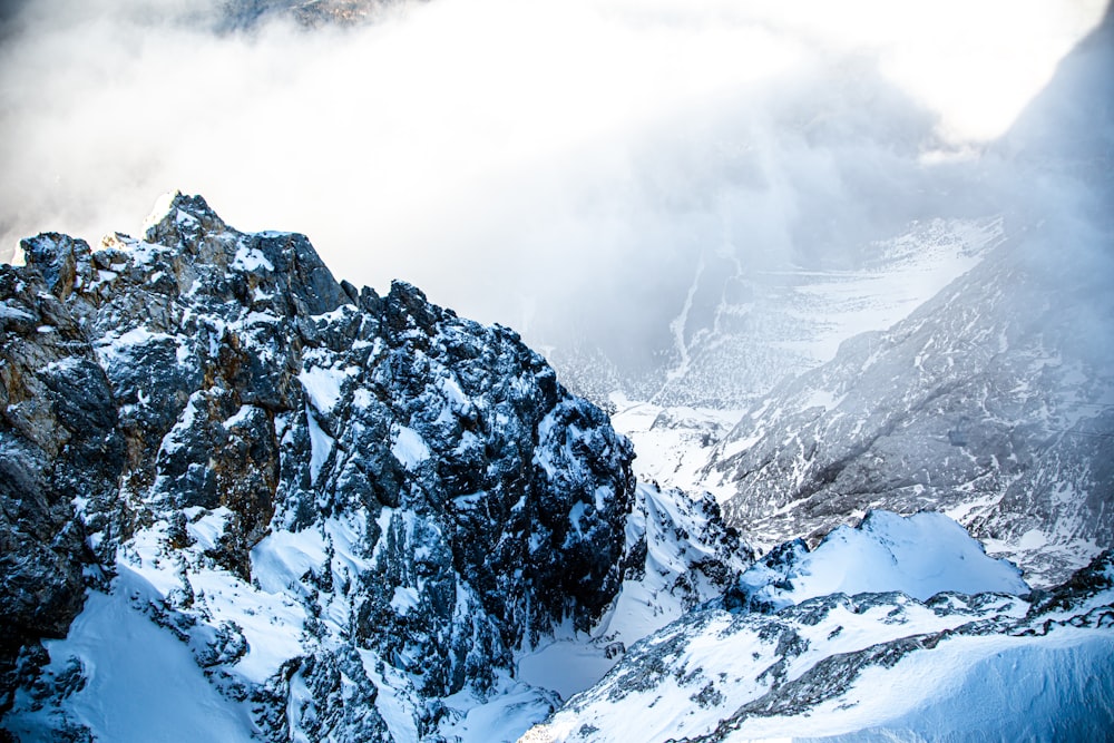 snow covered mountain under cloudy sky during daytime