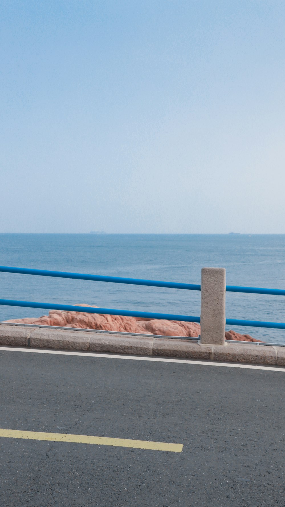 brown concrete wall near blue sea during daytime