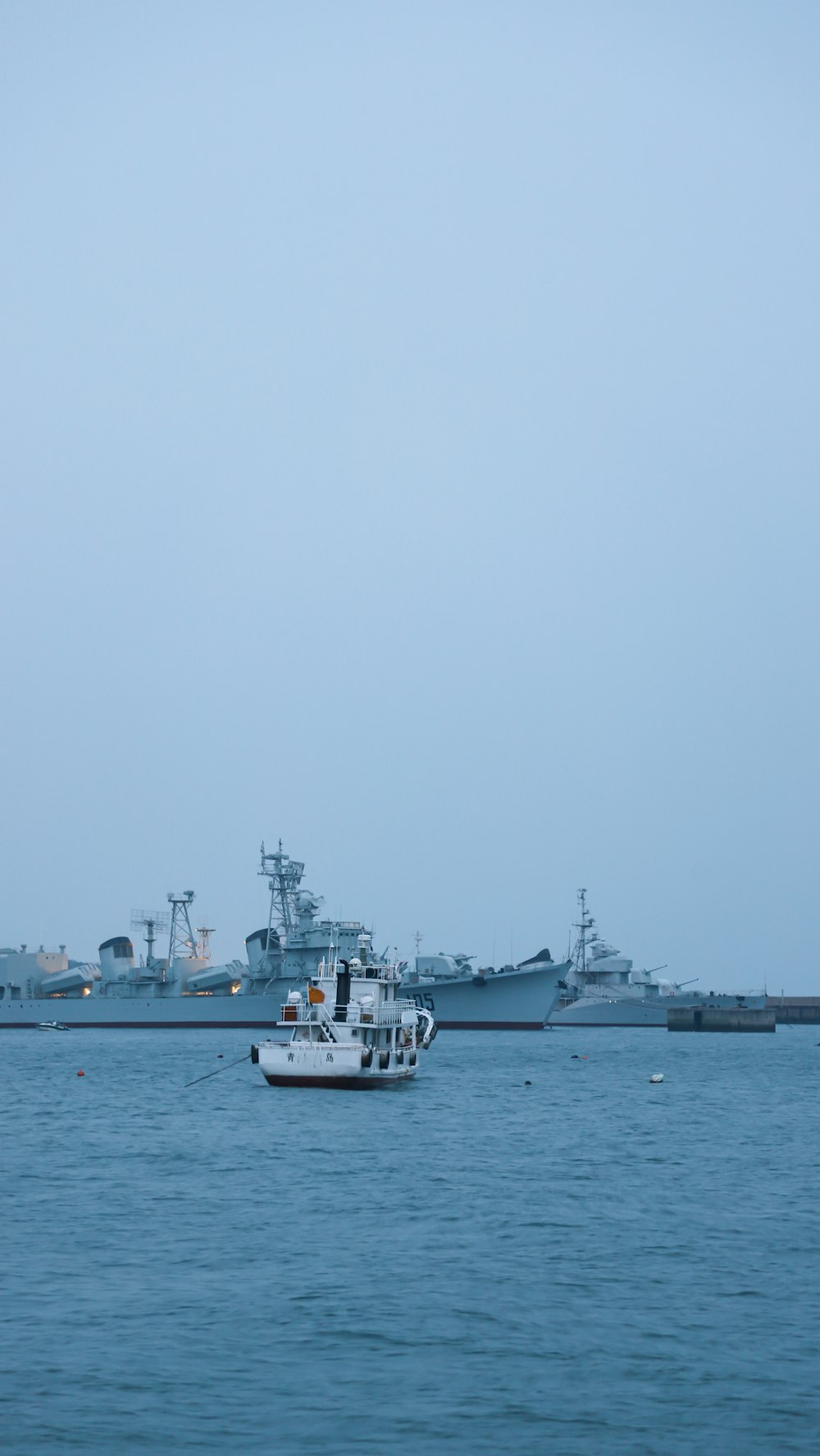 white boat on sea during daytime