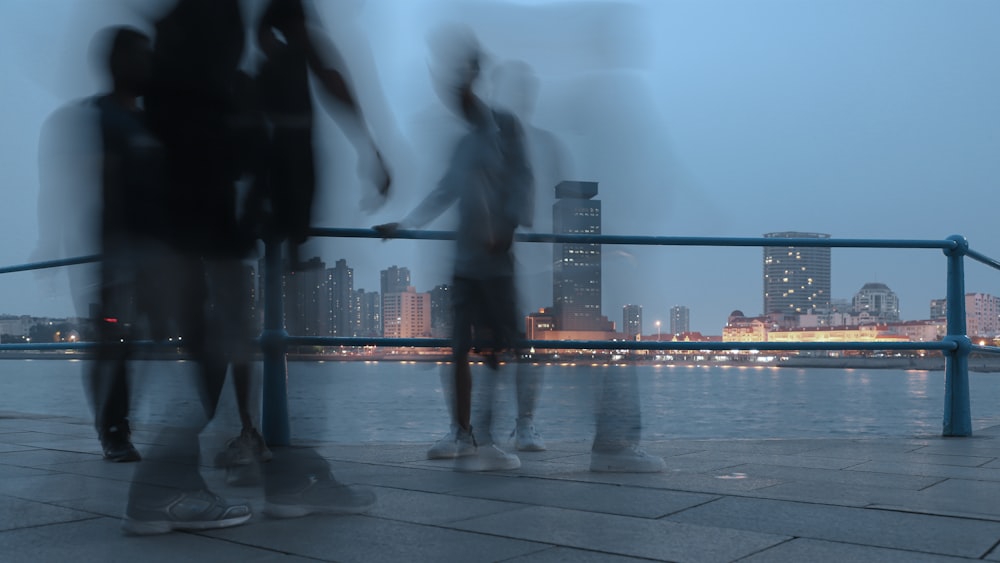 people walking on sidewalk near city buildings during daytime