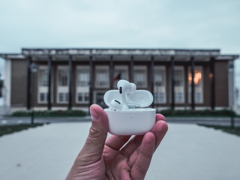 person holding white ceramic teacup