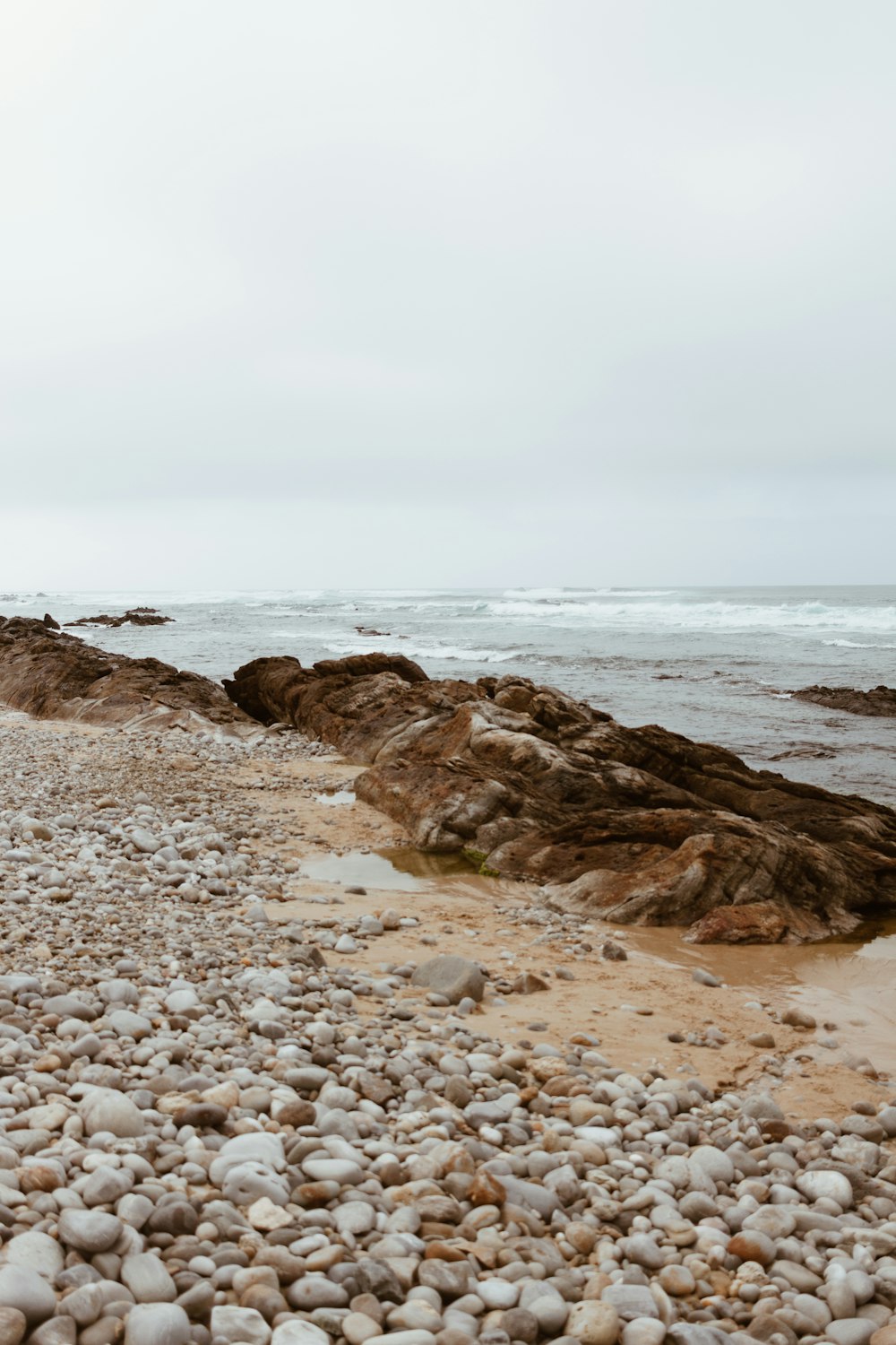 brown rock formation on sea shore during daytime