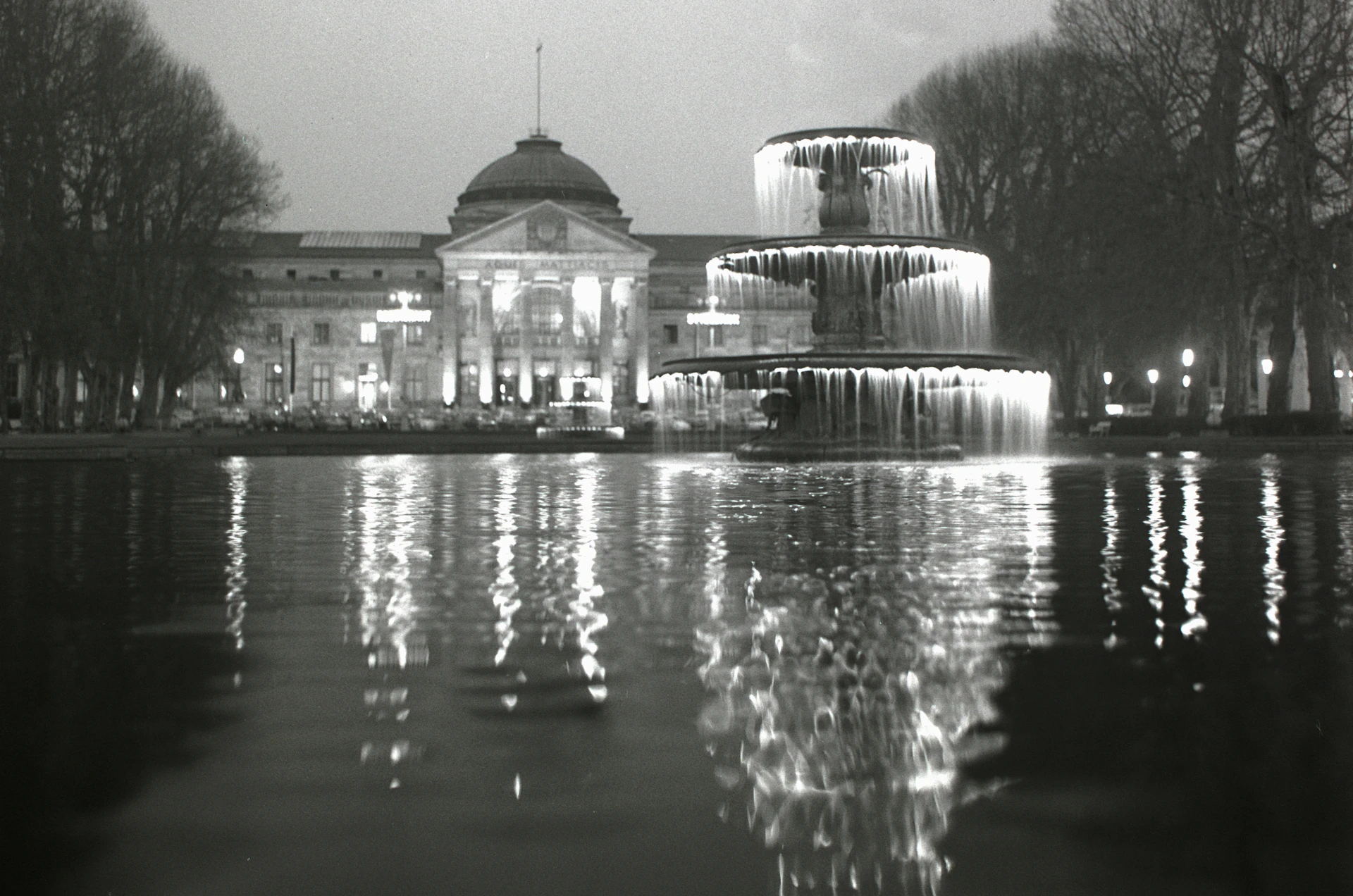grayscale photo of building near body of water
