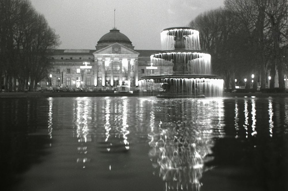 grayscale photo of building near body of water