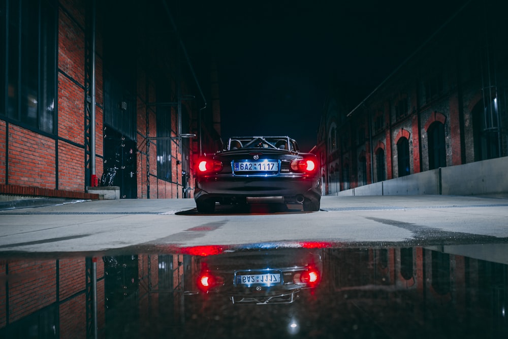 black car on road during night time