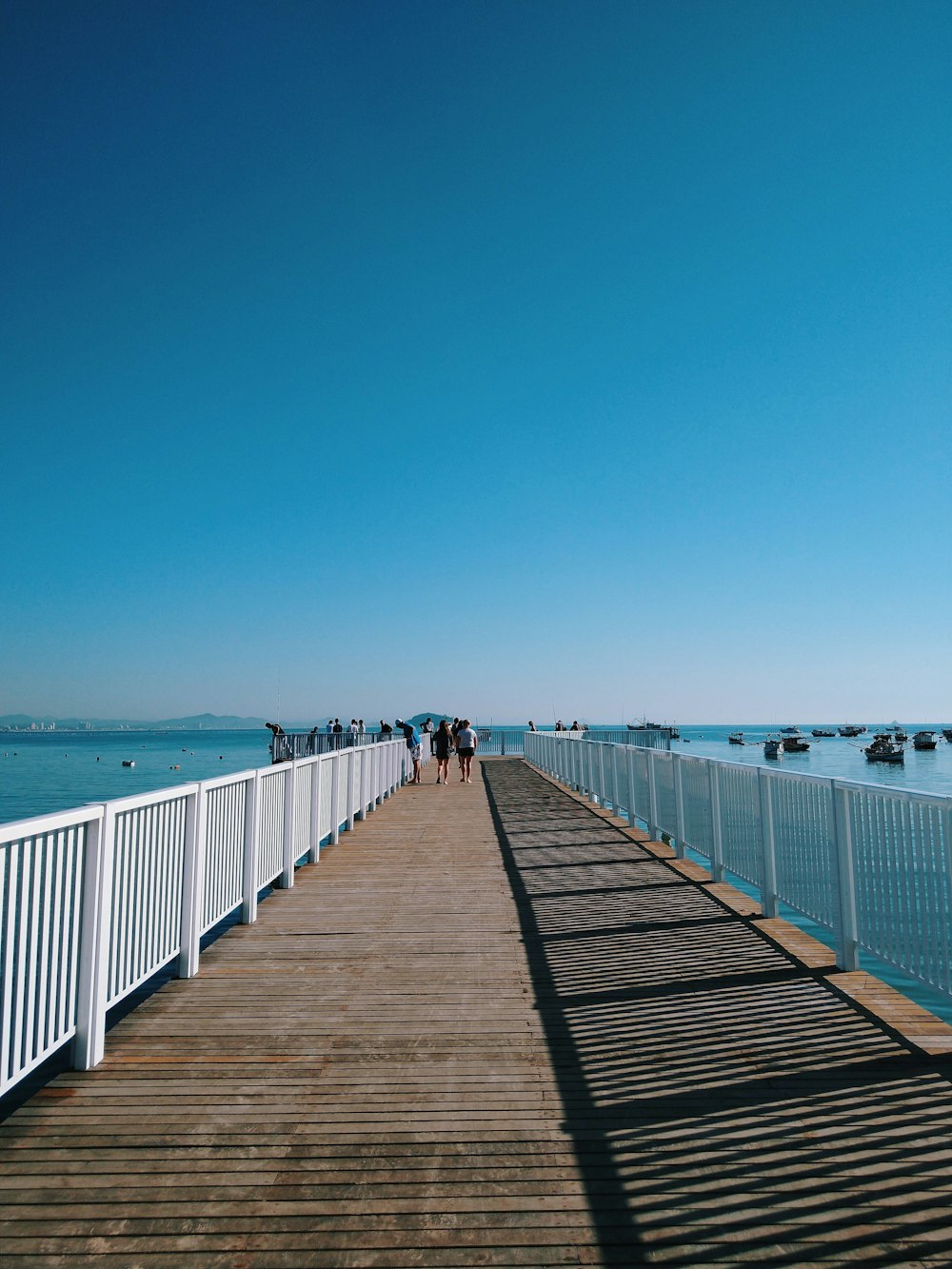 people walking on wooden dock during daytime