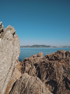 a rock outcropping with a body of water in the background