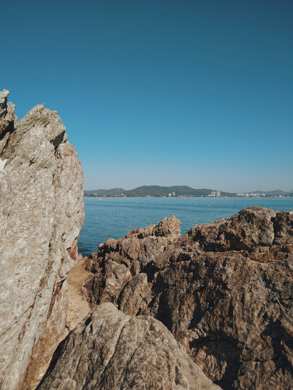 a rock outcropping with a body of water in the background