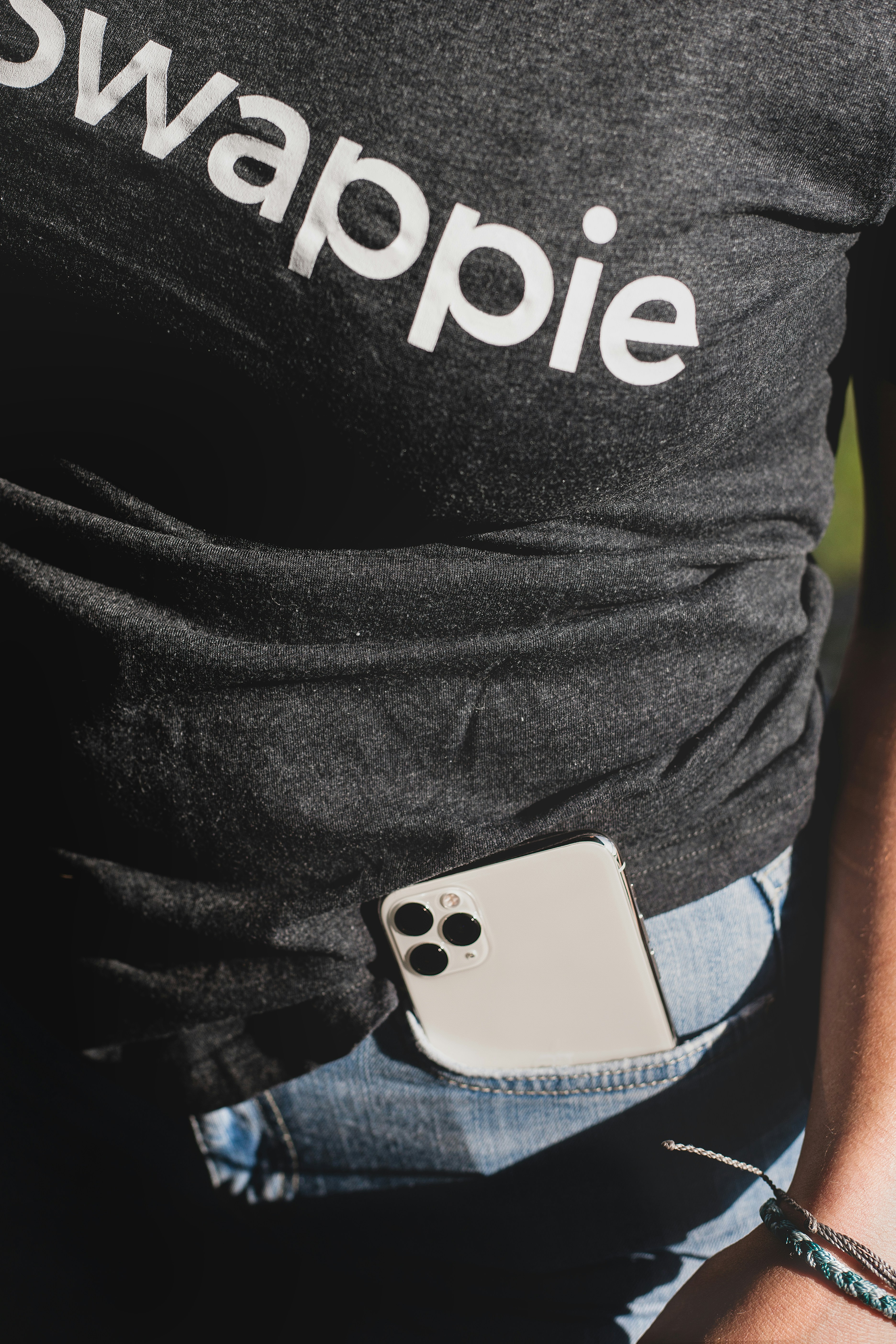 white iphone 4 on black and white adidas shirt