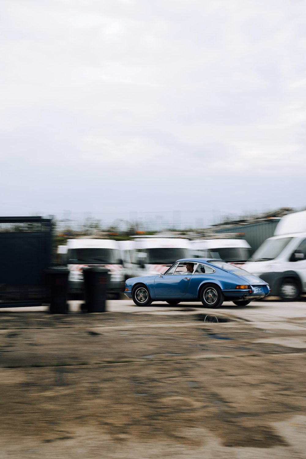 blue sedan on road during daytime