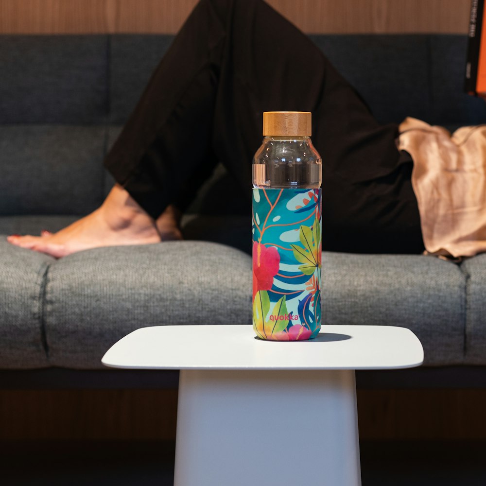 clear glass bottle on white table