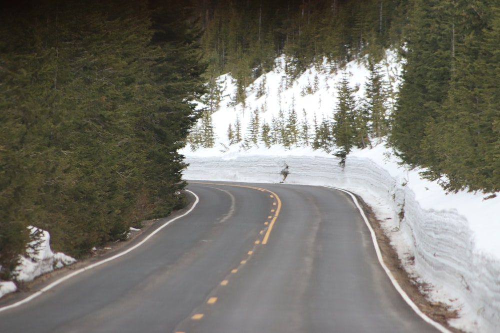 a car driving down a snow covered road