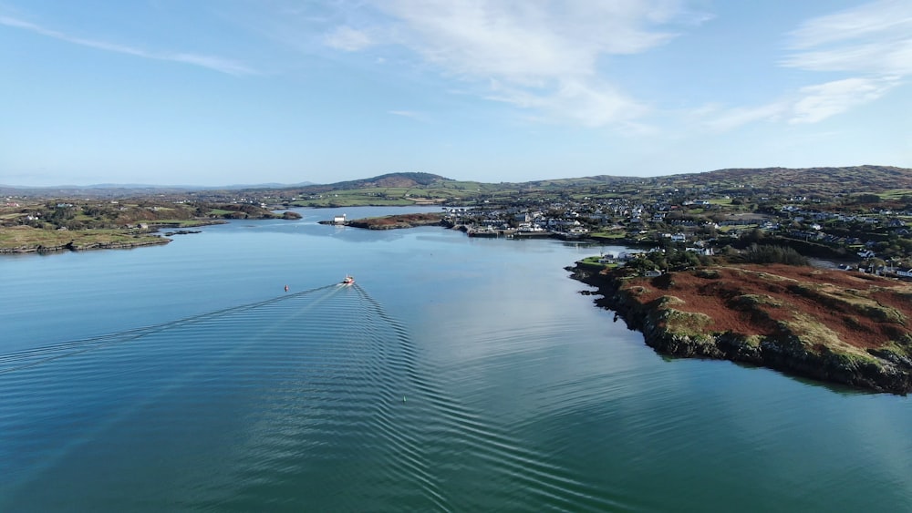 body of water near green trees during daytime