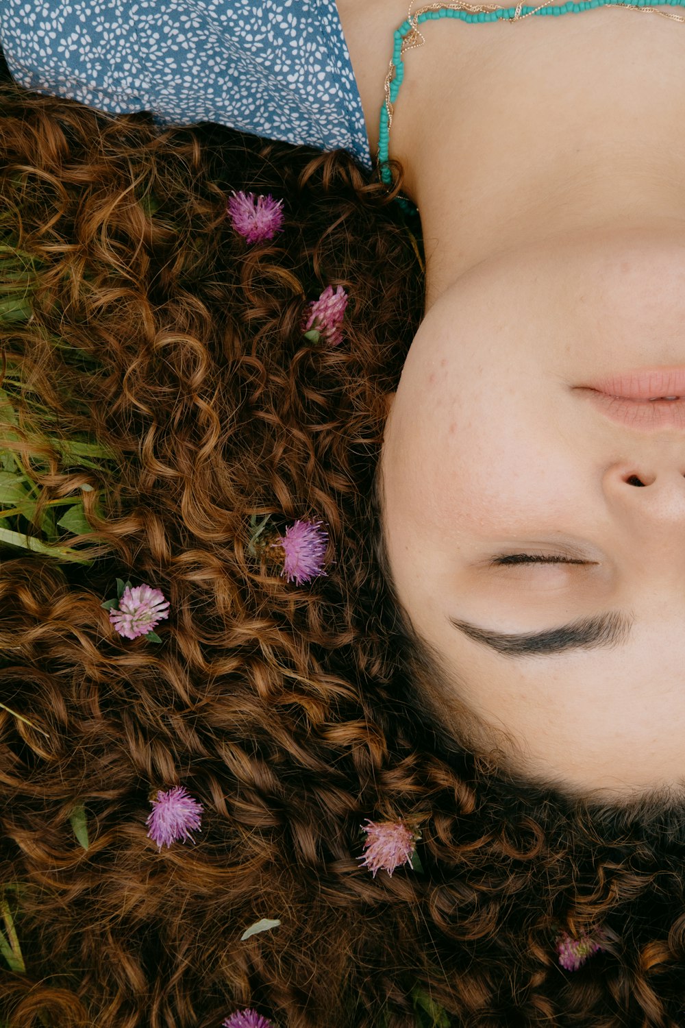 woman with purple flower on her ear